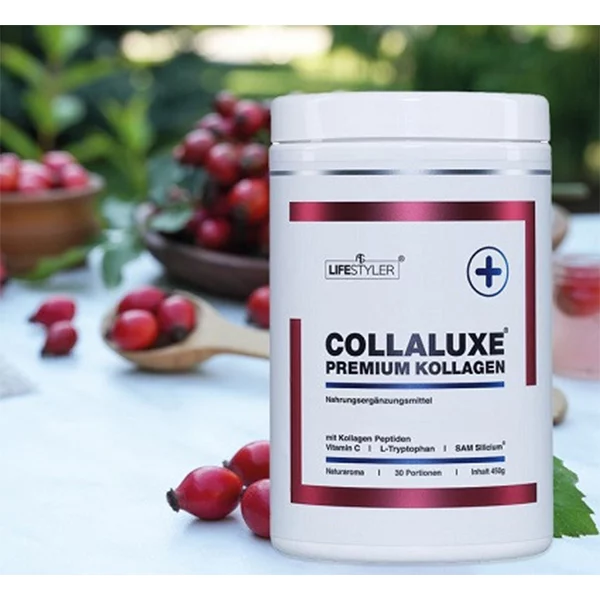 A white container of Collaluxe Premium Collagen stands on an outdoor table, surrounded by rose hips and green foliage in the background. The label features red accents and the most important product information.